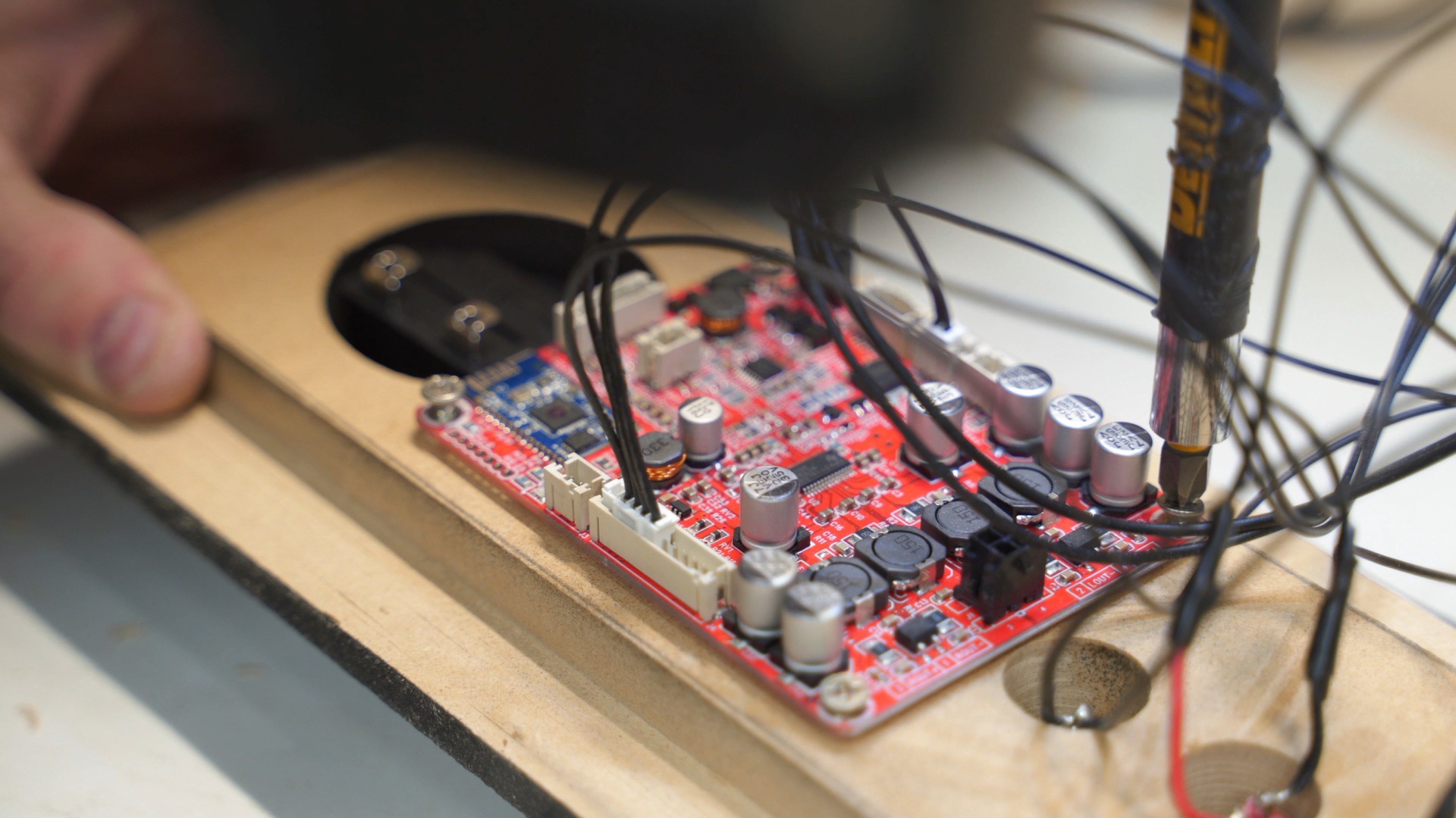 Attach the soundboard with screws to the Bluetooth speaker back